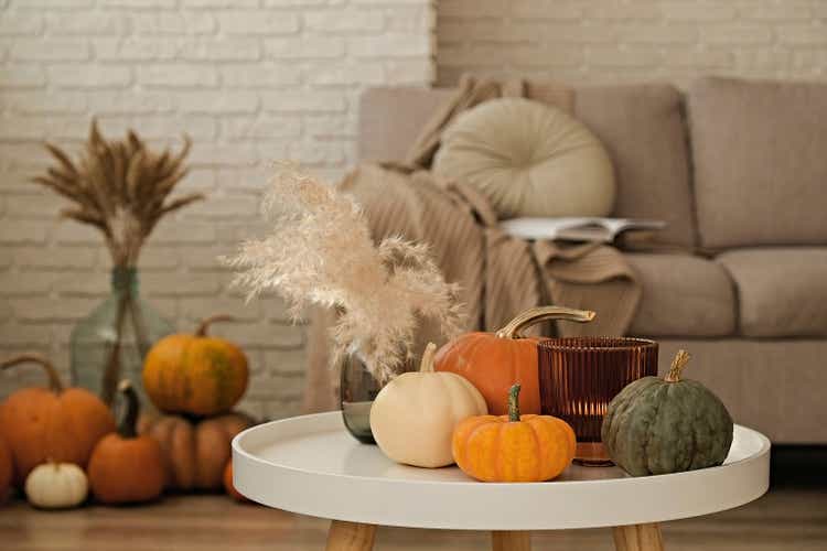 Room decorated with pumpkins and candles