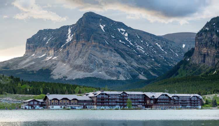 Glacier Nation park lake and distant lodging in the mountains