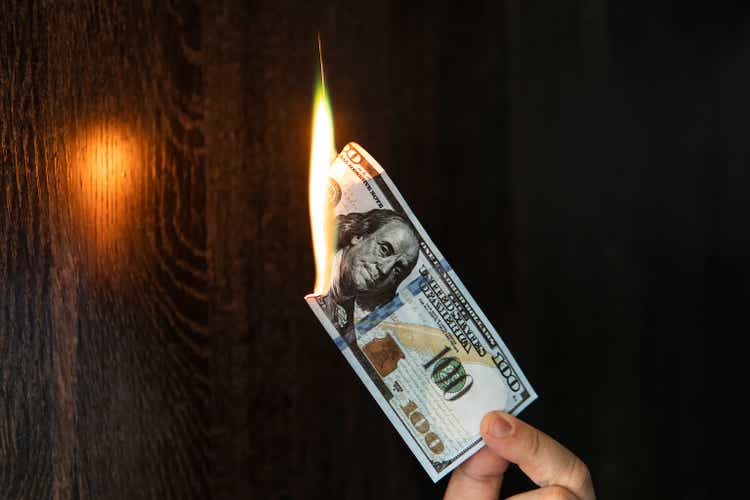 One Hundred Dollars are burning on black background.