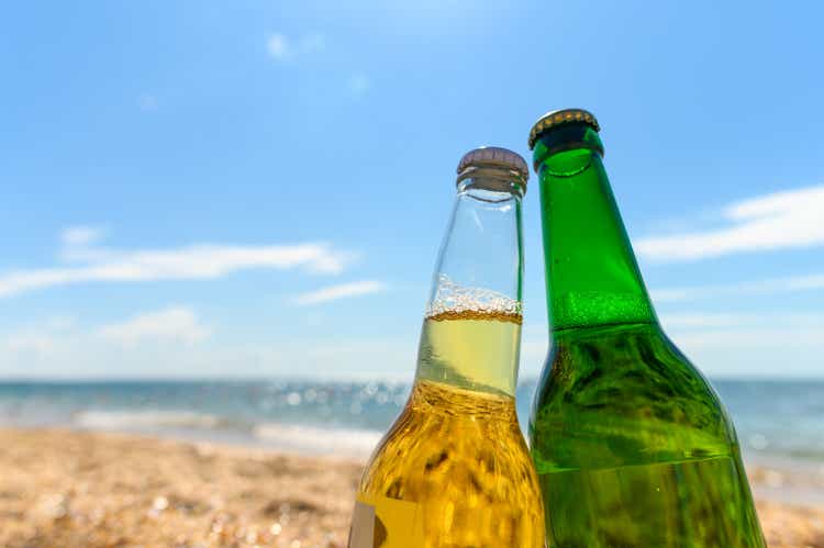 Two bottles of beer close-up on the beach. Sea vacation concept