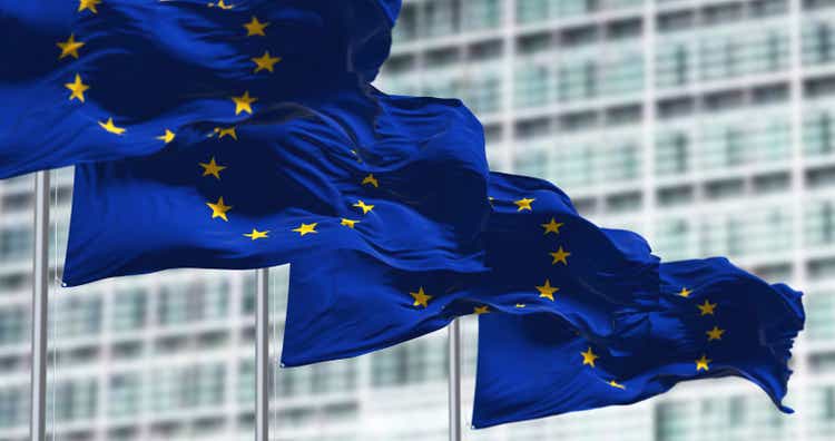 group of flags of the European Union waving in the wind