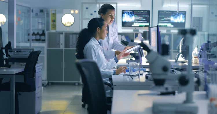 Drug trial, medical research or examination of a scan being done by doctors, researchers or scientists in a lab. Experts, medical professionals or biologists talking and discussing results of a test