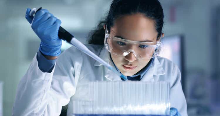 Research, experiment and medical trial being done by a scientist in a lab, science facility or hospital. One young, serious and professional researcher organizing, sorting or making a discovery