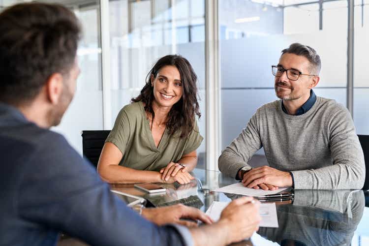 Mature couple meeting financial advisor for investment