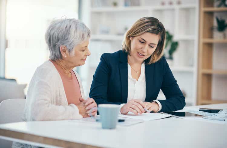 Retirement planning, wealth management and financial advice with a senior woman and her advisor, broker or investment agent.  Talk, discuss and plan savings, finance and wealth for the future