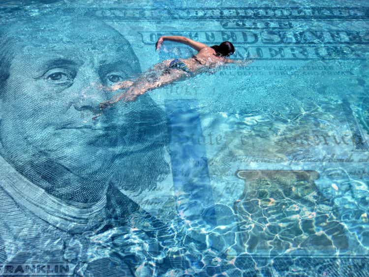 Wealth and success concept of swimming in money