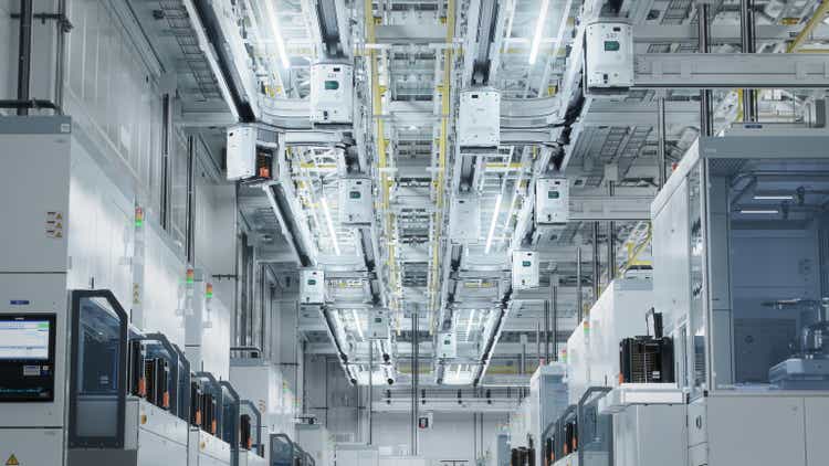 Wide Shot Inside Bright Advanced Semiconductor Production Fab Cleanroom with Working Overhead Wafer Transfer System