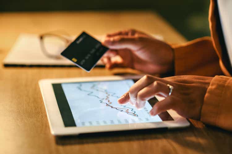 Hands of shopping businesswoman using tablet to make purchases or trading online, woman comparing prices while online before making payments. Female holding credit card and using digital tablet.