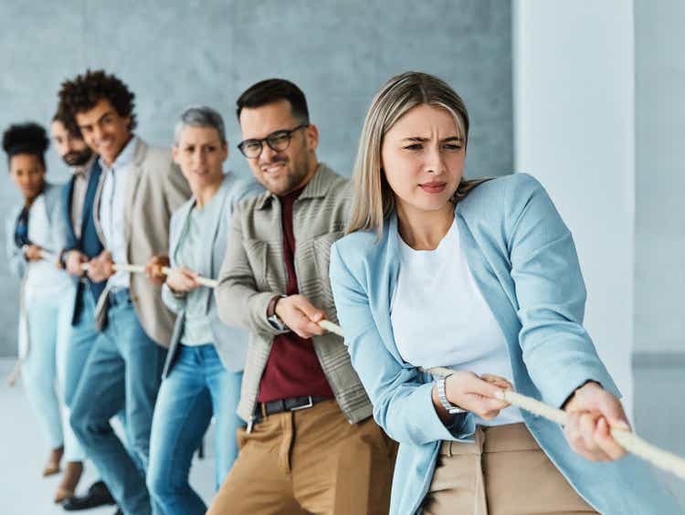 businessman man business young businesswoman woman office rope concept competition pull strength challenge teamwork effort pulling rivalry power struggle determination achievement startup