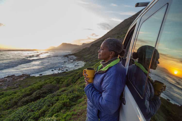 Mature woman enjoying sunset by the sea