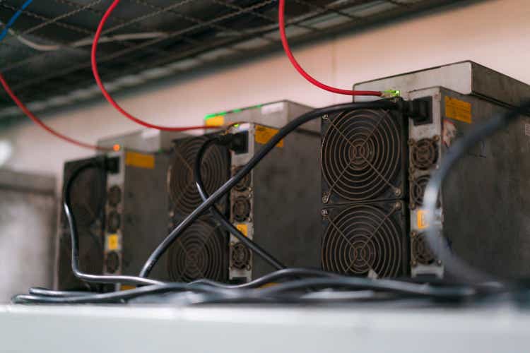 ASIC mining equipment for cryptocurrency on steel container. Bitcoin miners in farm.