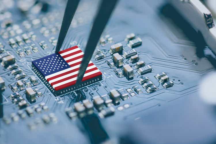 Flag of USA on a processor, CPU Central processing Unit or GPU microchip on a motherboard. Congress passes the CHIPS Act of 2022 to strengthen domestic semiconductor manufacturing, research and design.