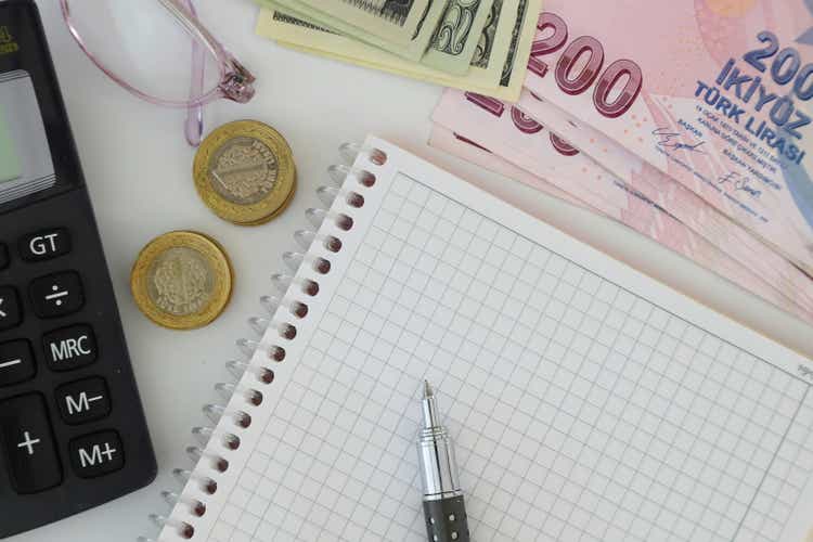 dollar, eruo and turkish lira with a Calculator and a Pen