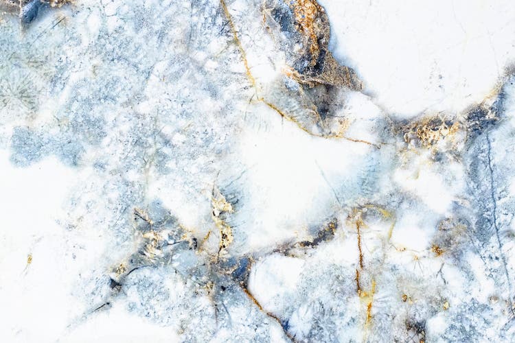 White marble with blue and golden orange patterns