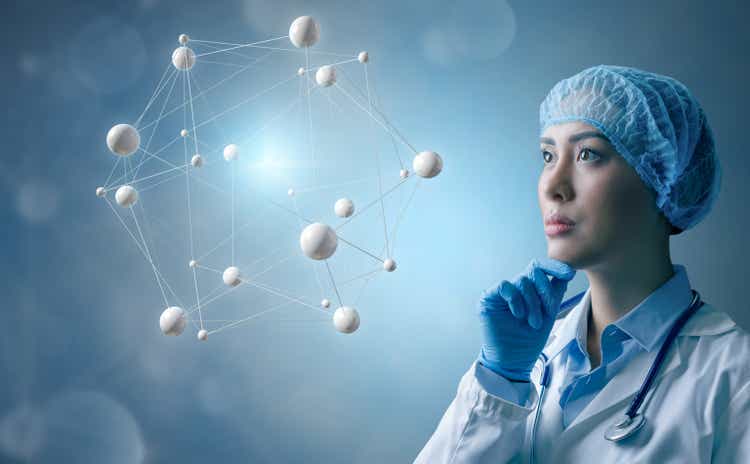 Female physician contemplates molecular structure