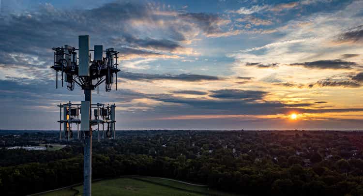 5G mobile cell phone repeater tower on the hill of a park in the mid west city of Lexington, KY during dramatic sunrise.