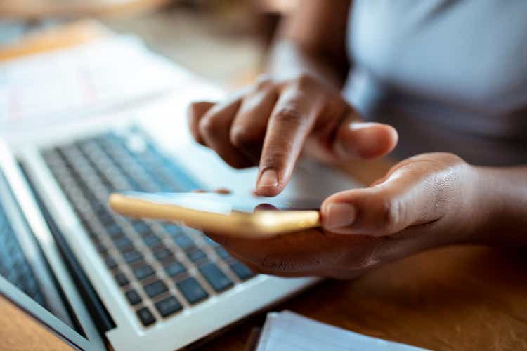 Mid adult woman using a banking app on her phone