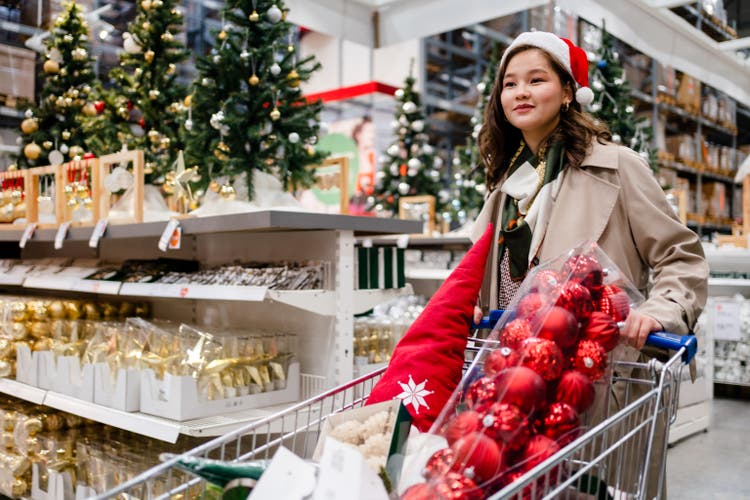 happy young woman doing shopping at Christmas market