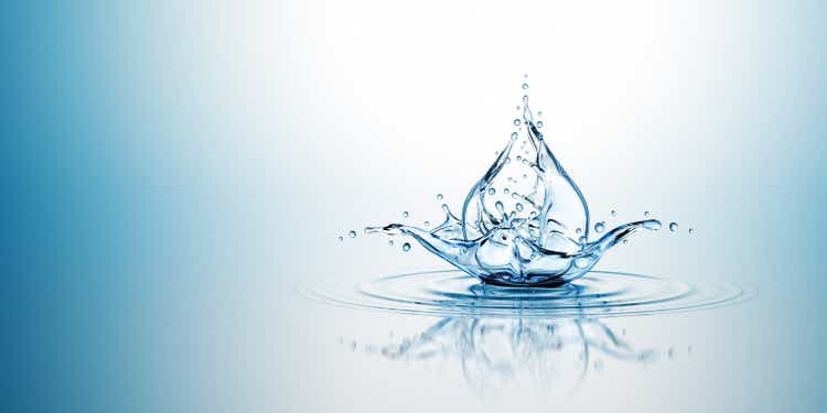 Water Drop Splash. On The Blue Background.