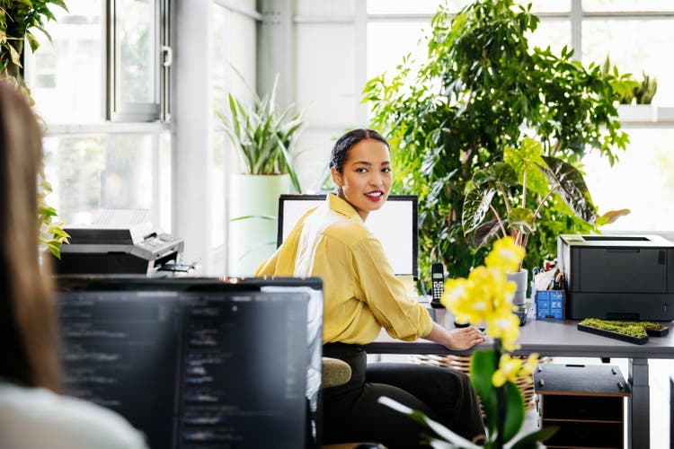 Woman Turning Head While Sitting At Computer Desk