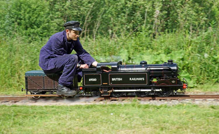 Miniature Steam train and driver in the park.