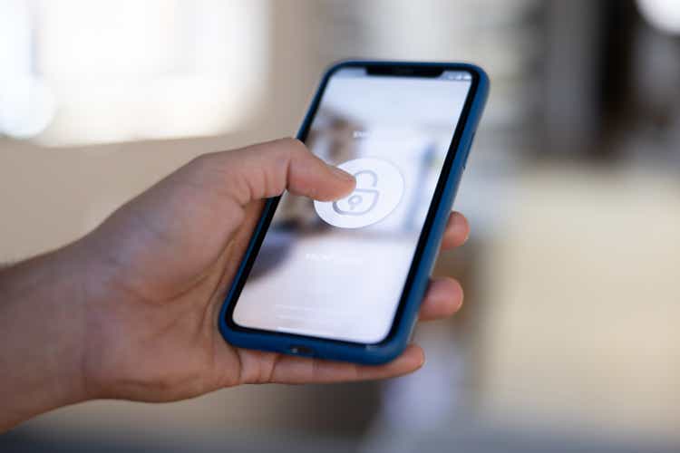 Man locking his house using a home automation app