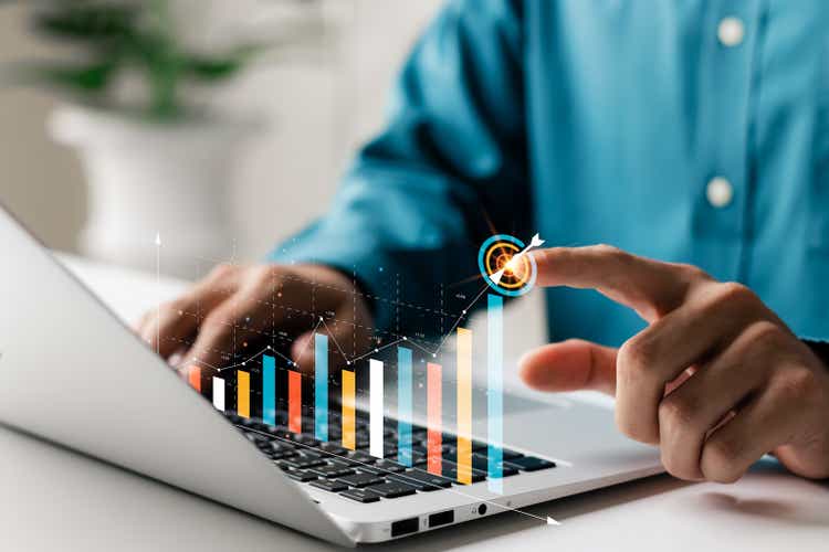 Businessman analyzing company"s financial balance sheet working with digital augmented reality graphics. Businessman calculates financial data for long-term investment.