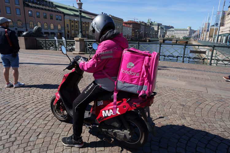 Gothenburg, Sweden - March 13, 2022: Foodora delivery man driving to delivery address