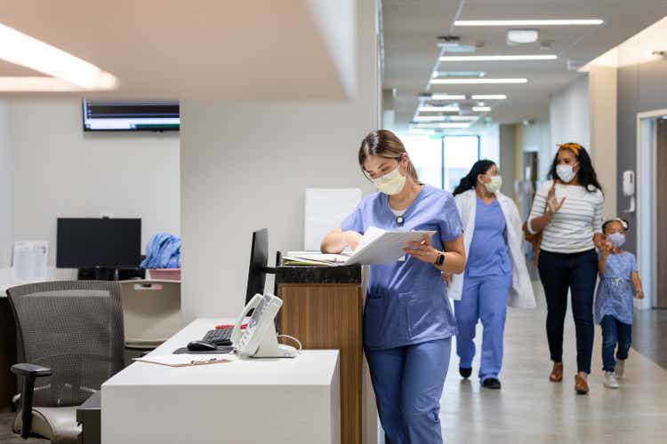 Doctor walks patient to their room