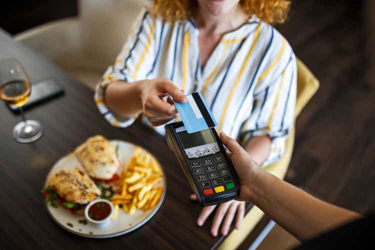 Smiling young making payment with credit card ,focus on credit card