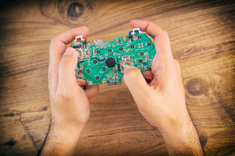 Hands Holding Motherboard Of A Gamepad