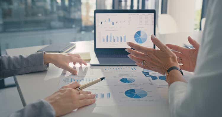 Data analysis, marketing strategy or statistics by business development leaders planning company growth. Hands of finance managers in a meeting talking about financial performance in an office