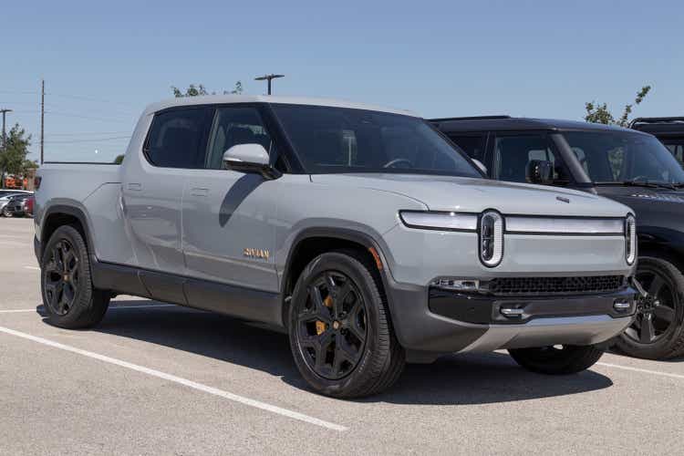 Rivian R1T Pickup Truck display at a dealership. Rivian offers the R1T in Explore, Adventure and Launch models.