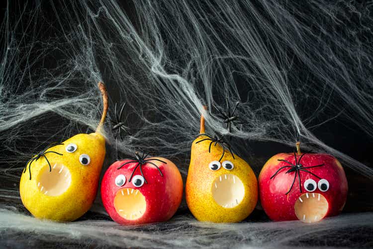 Halloween background. Creepy fruits on a dark background. Halloween food. Banner. Copy space.