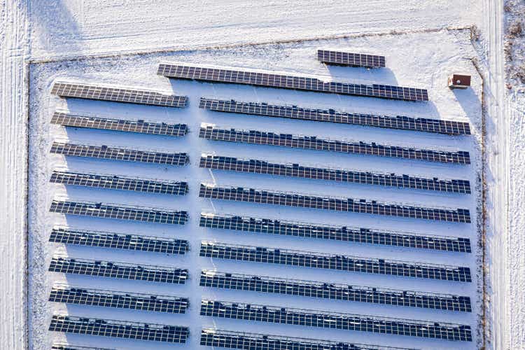 Snowy photovoltaic farm in winter. Alternative energy in Poland