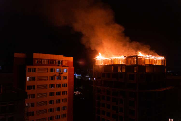 Burning building roof at night