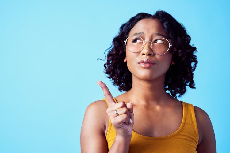 Confused woman, thinking direction and studio mockup background. Pensive, annoyed or curious person contemplating decision. Girl with solution or idea pointing for marketing advertisement.