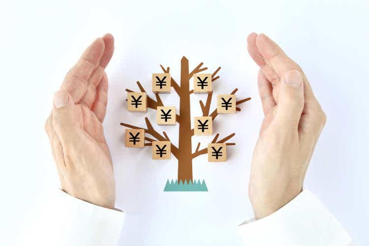 Male hands and wooden blocks with Japanese yen mark on tree illustration