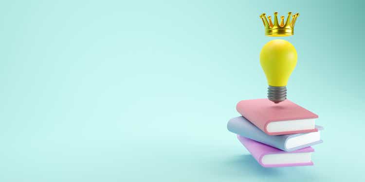 3D rendering of Light bulb with crown, Symbol of the idea over color books on pastel background