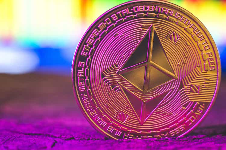 World cryptocurrency. Ethereum coin in purple neon light close-up. Financial system of the future - Ukraine, Izmail 17.03.22