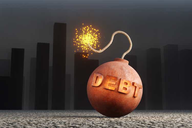 Ignited debt bomb in front of a foggy city. 3D illustration of the concept of mortgage debt and increasing prices of real estate properties