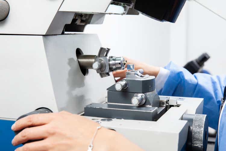 Closeup of a female scientist using an ultramicrotome to make sections for the electron microscope
