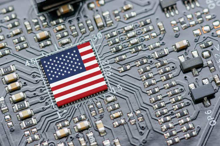 Flag of USA on a processor, CPU Central processing Unit or GPU microchip on a motherboard. US firms have become the latest collateral damage in US-China tech war. US blocks sales of AI chips to China.