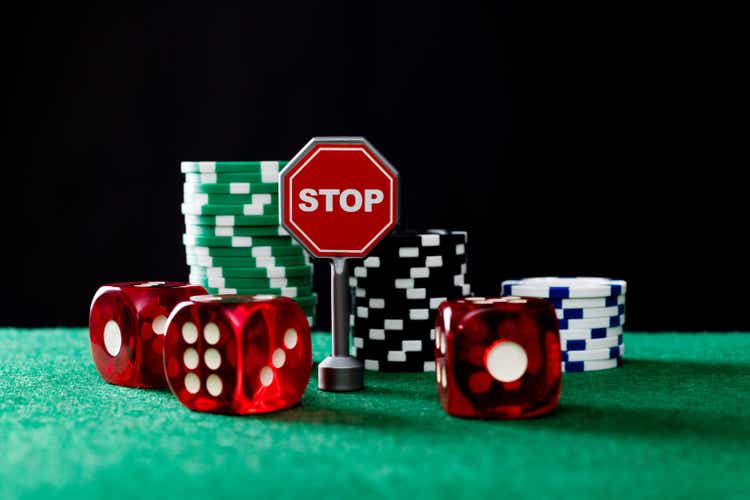 Gambling chips and stop sign on the table