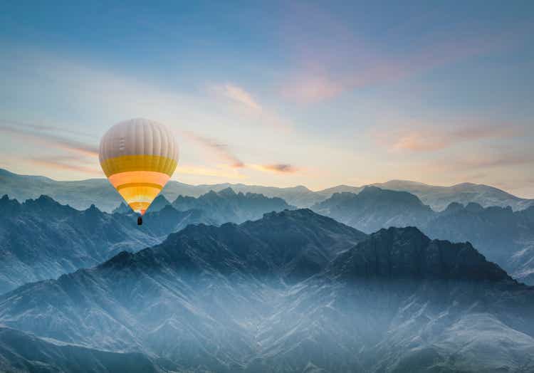Hot air balloon flying over rocky mountains in TURKEY