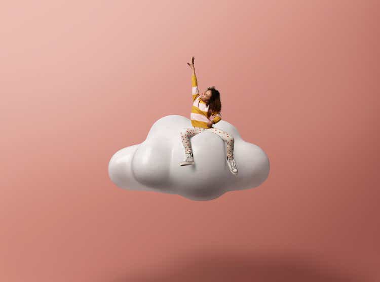 Girl with hand raised gesturing on cloud