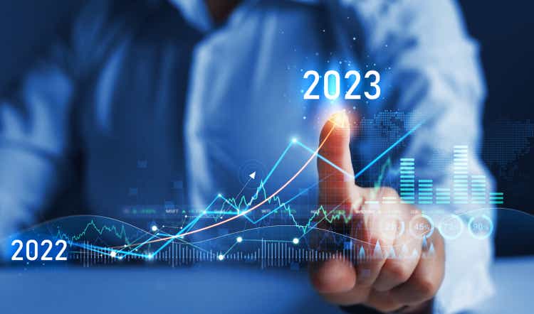 Business person draws increase arrow graph corporate future growth year 2022 to 2023. New Goals, Plans and Visions for Next Year 2023.