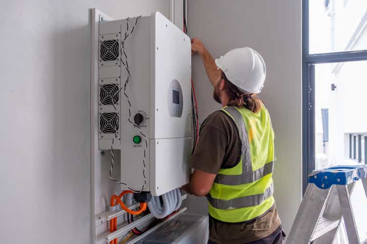 Electrician connecting a solar inverter