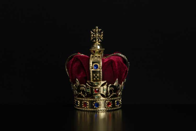 Golden crown on a black background with copy space