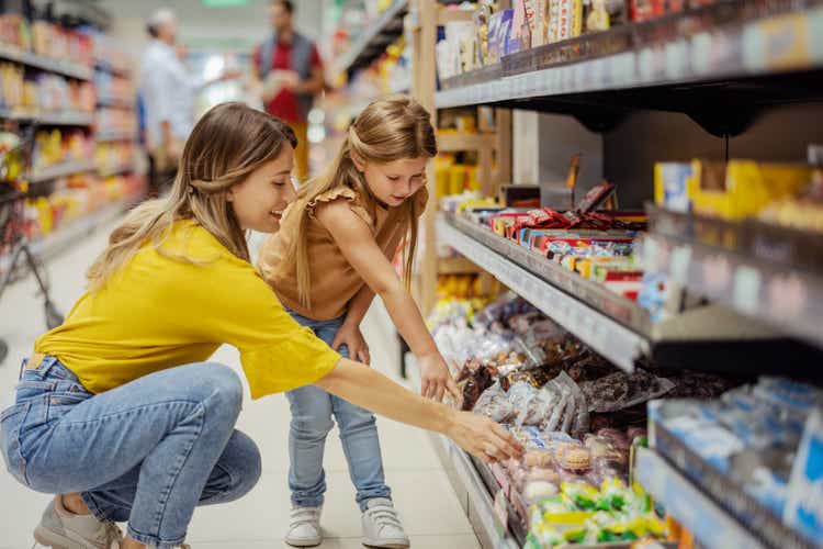 Mother and Girl Daughter in the Supermarket